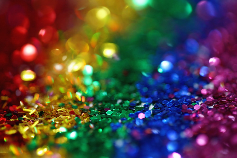 Black glitter background with multicoloured splashes. Stock Photo