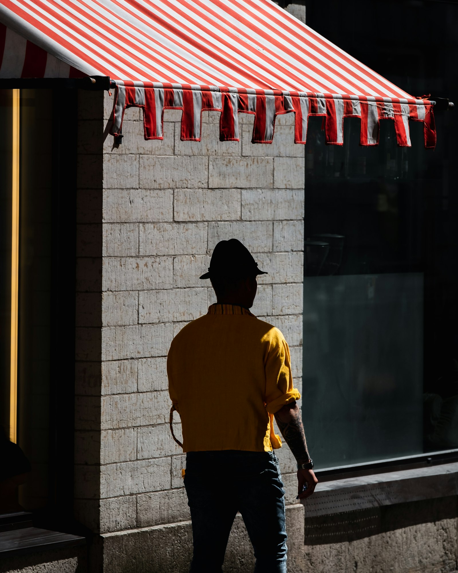 Fujifilm XF 50-140mm F2.8 R LM OIS WR sample photo. Man walking under red photography