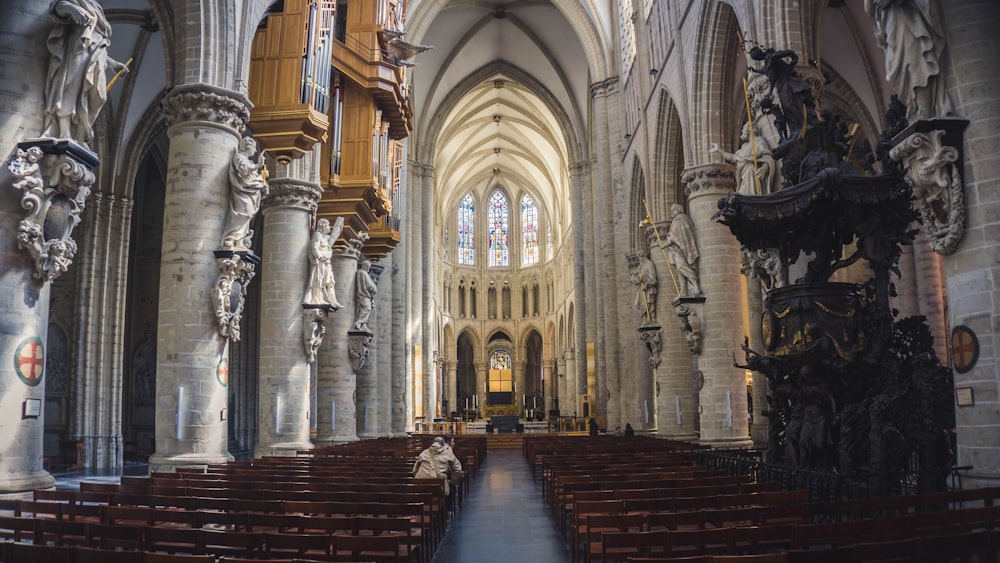 people sitting in pew inside cathedral