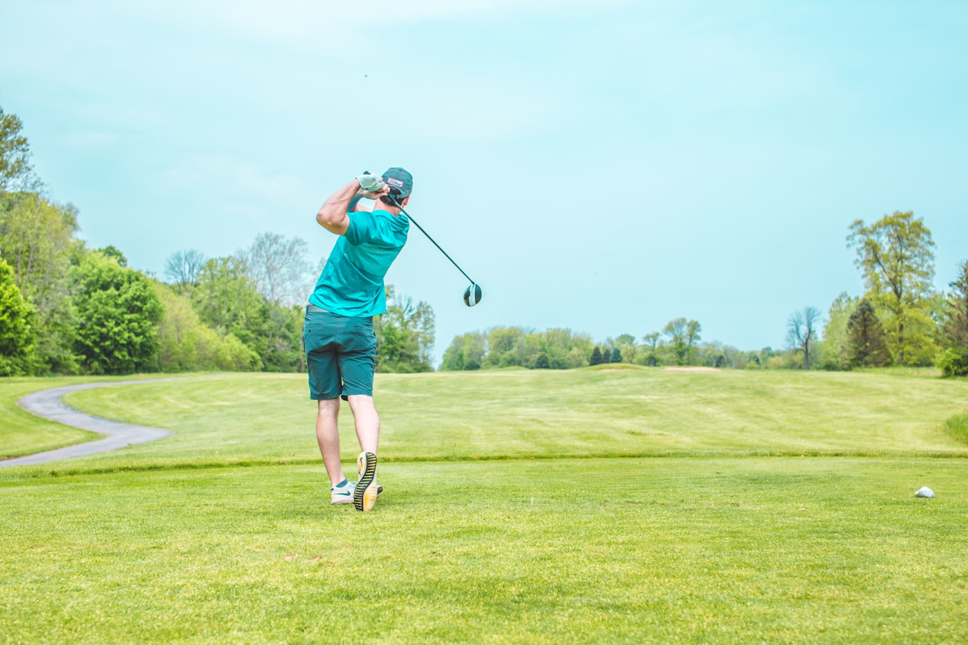 Moniteur de golf guidant un homme de 60 ans dans son swing sur le practice