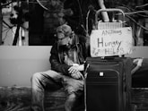 grayscale photography of man sitting on chair