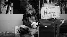 grayscale photography of man sitting on chair