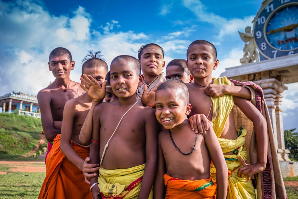 group children standing near an arch during daytime