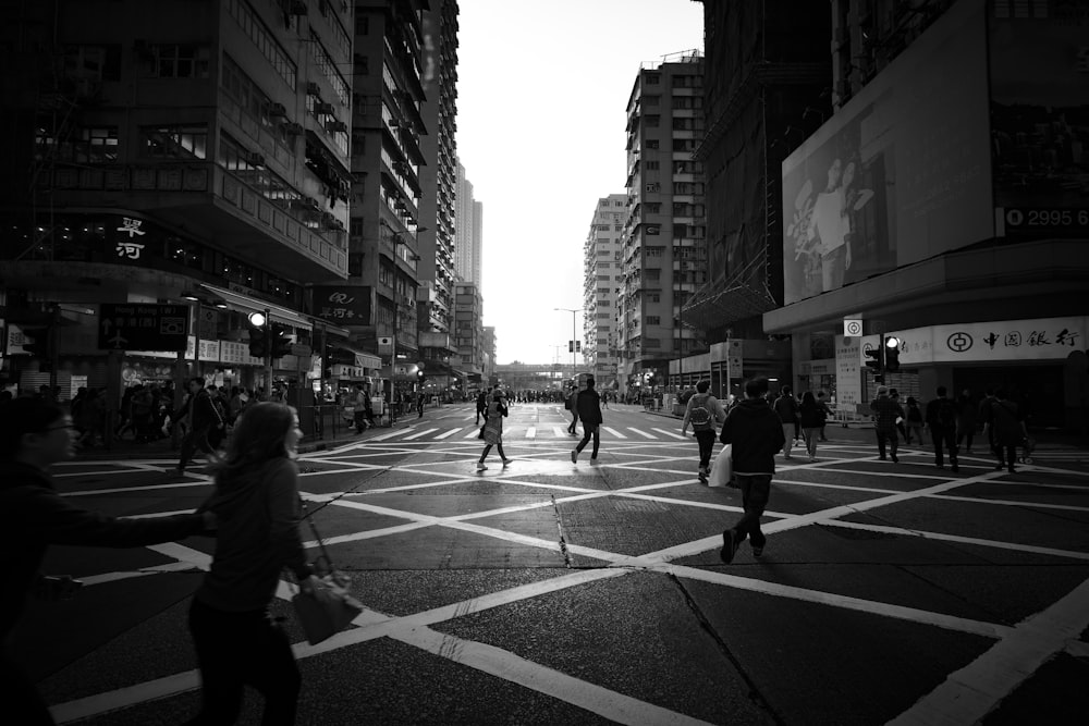 grasycale photo of people walking on road