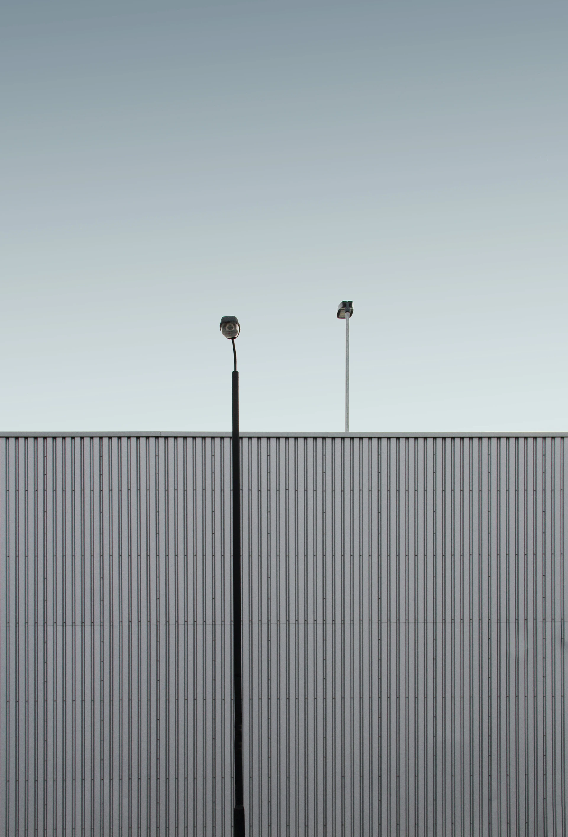 a couple of street lights sitting next to a tall building