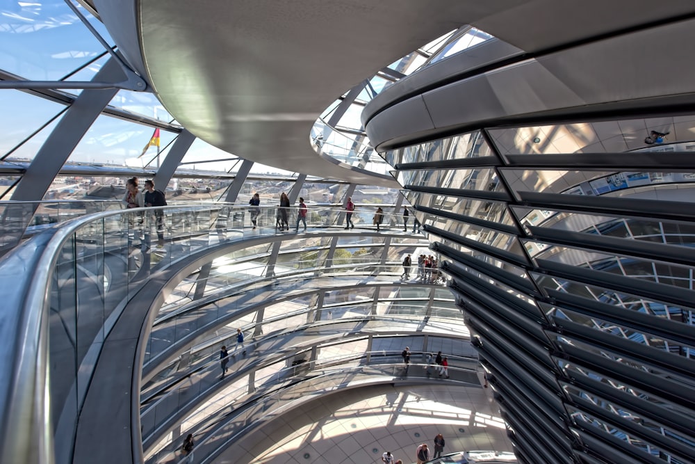 person walking inside clear glass wall building