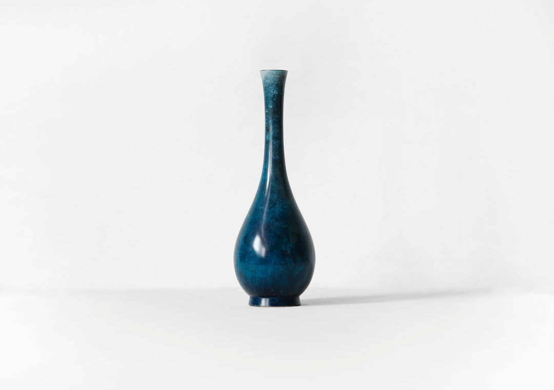 photography of blue ceramic vase against white background