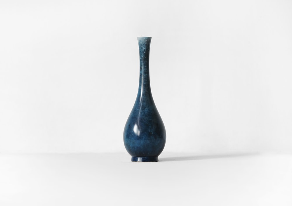 photography of blue ceramic vase against white background