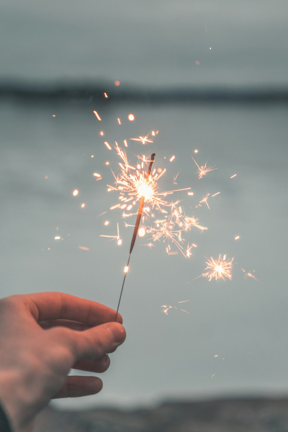 person holding sparkler