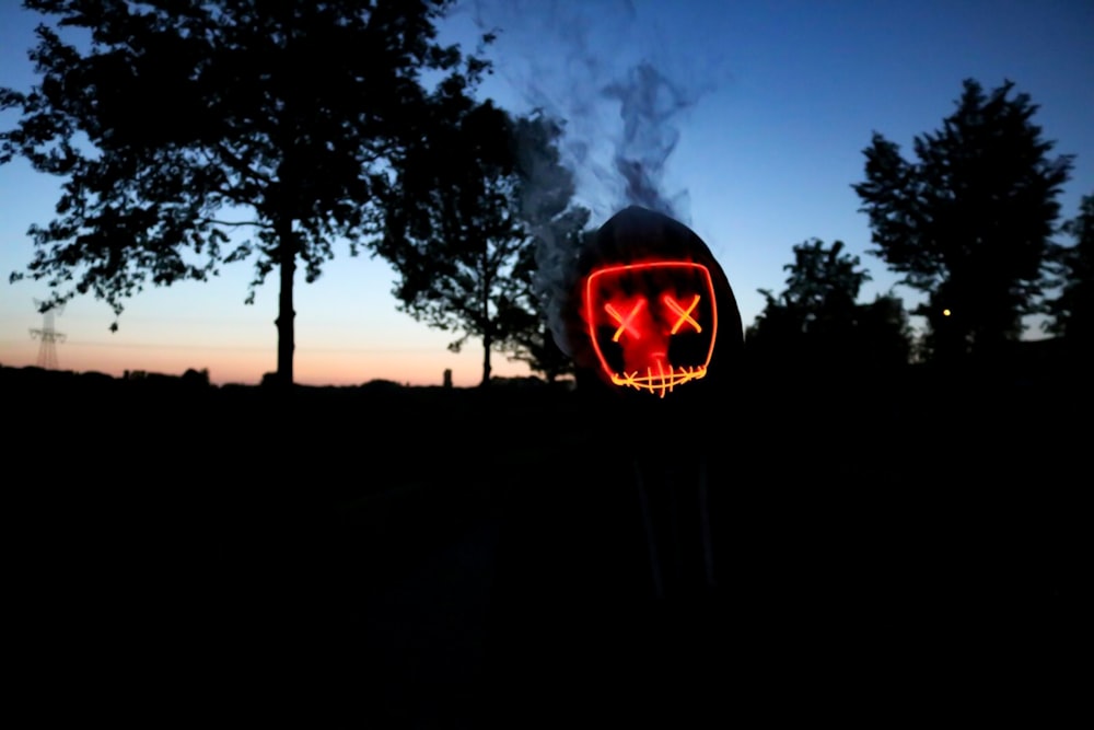 silhouette of trees smoking container with x mark