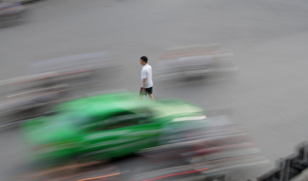 time lapse photo of man crossing the street