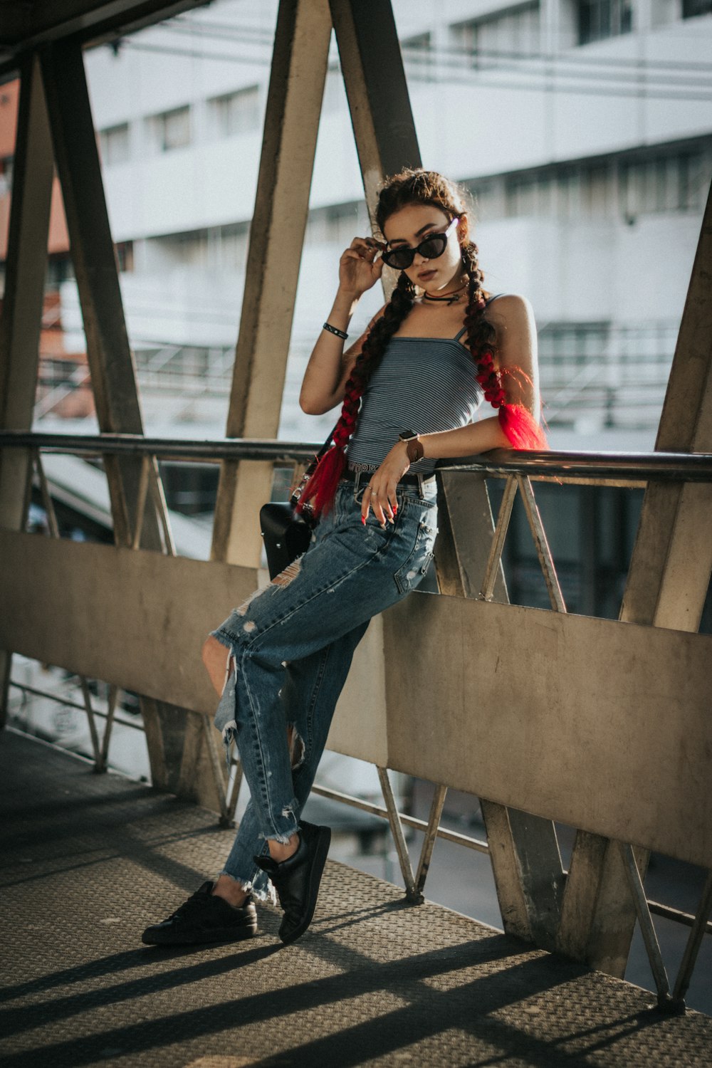 woman leaning on brown metal frame at daytime