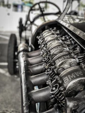 Close-up of genuine Mini Cooper spare parts neatly arranged on a workshop table.