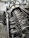 Close-up of a BMW engine being carefully serviced by a technician in a sleek, dark-toned workshop.