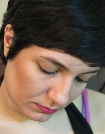 Close-up of a delicate facial treatment in progress with soft lighting.