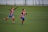 two boys running on grass field