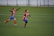 two boys running on grass field