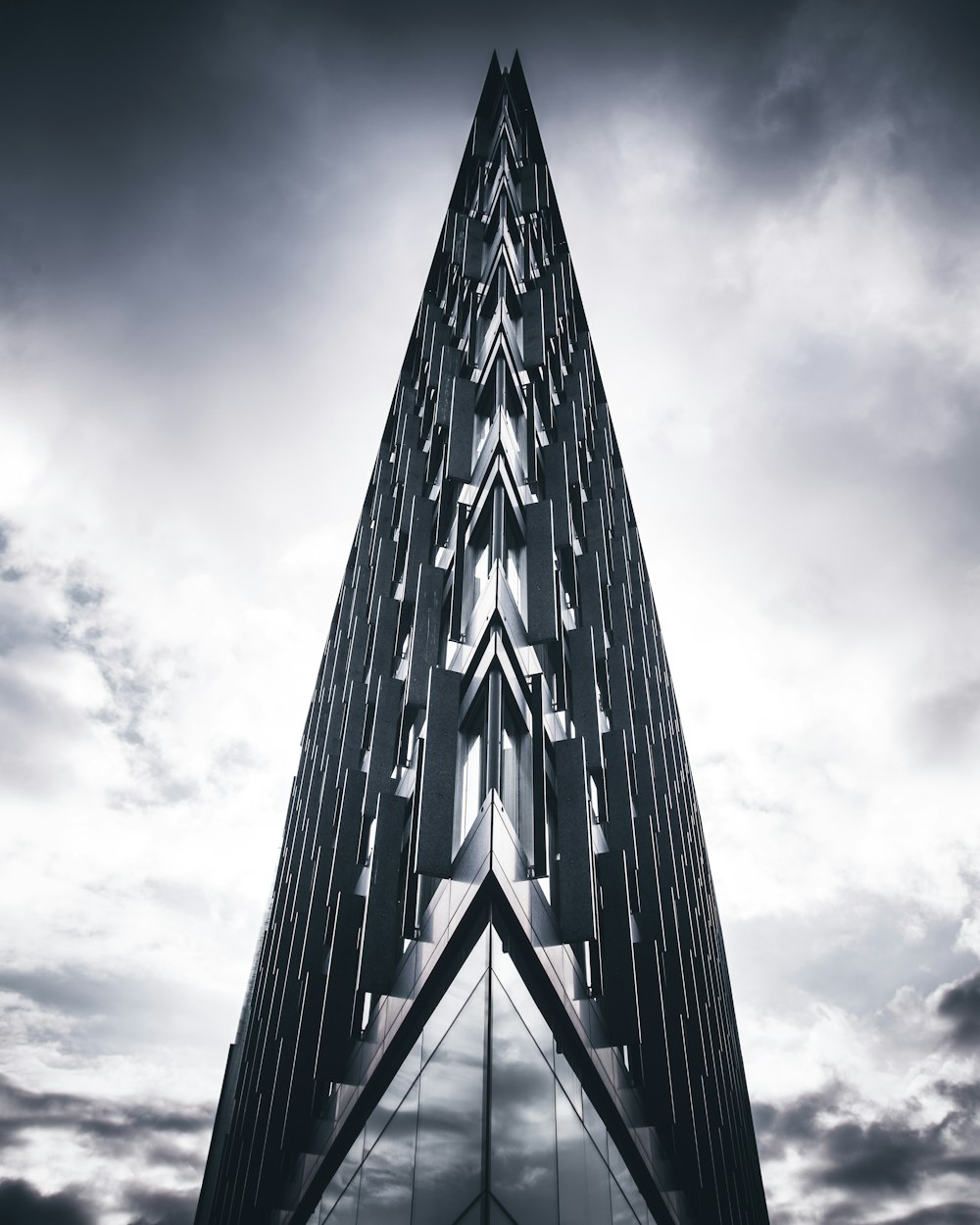 gray glass building under cloudy sky during daytime