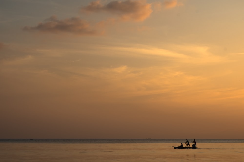 silhouette of people on boat
