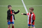 two boys in soccer field