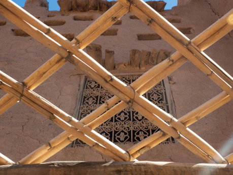 Close-up of a finely woven bamboo chick hanging on a sunny window.