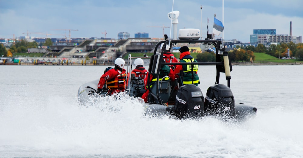 four person riding on inflatable boat