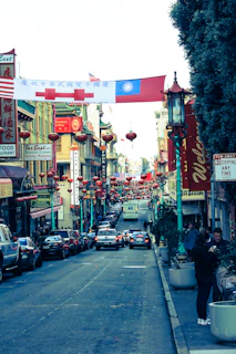 A vibrant street scene in Chinatown with colorful lanterns and bustling market stalls.