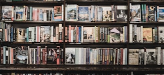 Wall-mounted bookshelves displaying an array of spiritual and metaphysical books