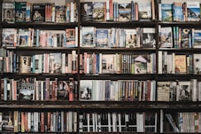 Wall-mounted bookshelves displaying an array of spiritual and metaphysical books