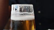 Close-up of frosty craft beer glasses with foam on top.