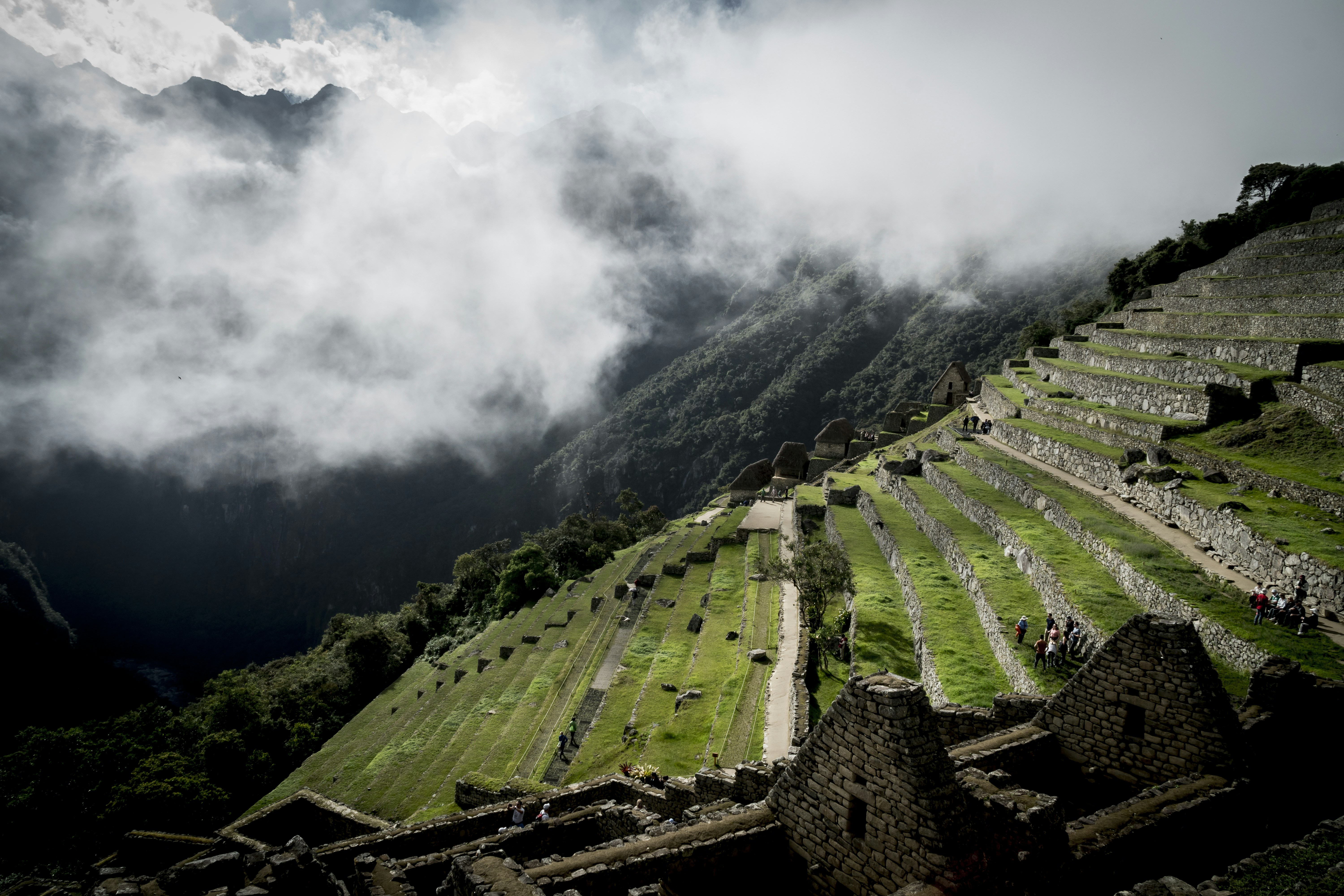 step vegetation landscape under white clouds at daytime, Inca constructions in Machu Picchu