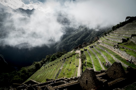 step vegetation landscape under white clouds at daytime in Machu Picchu Peru
