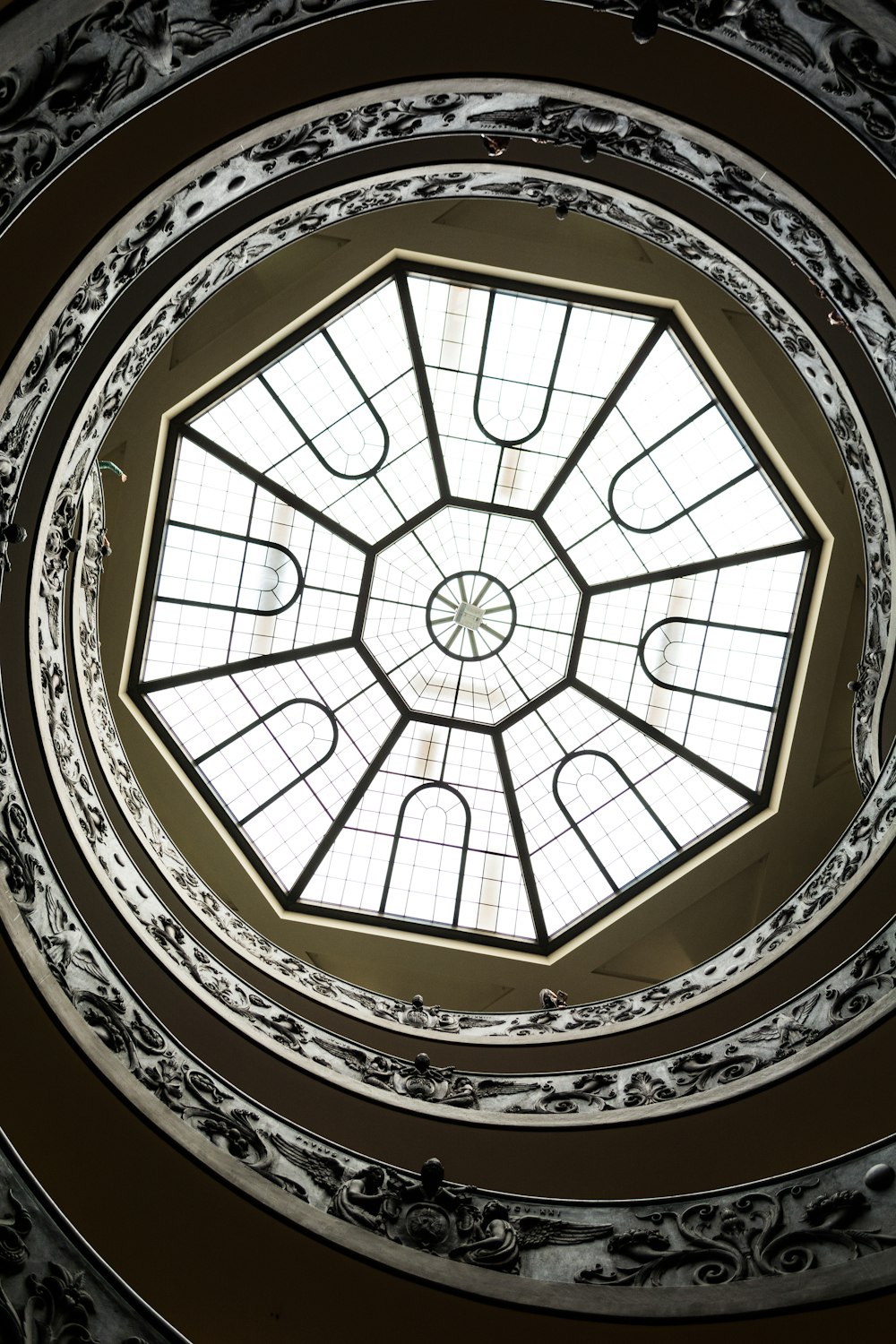 worm's eye view of white and black spiral stair