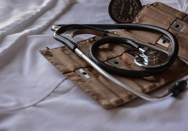 black stethoscope with brown leather case