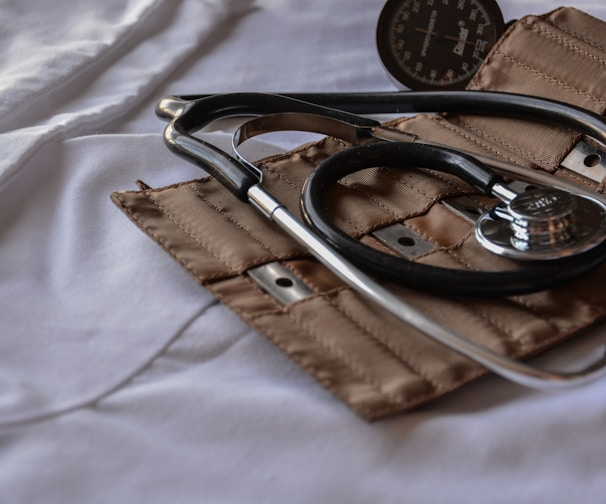 black stethoscope with brown leather case