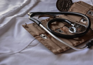 black stethoscope with brown leather case