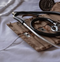 black stethoscope with brown leather case