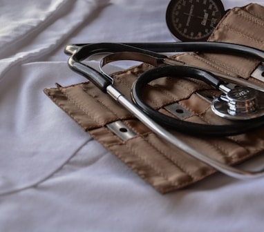 black stethoscope with brown leather case