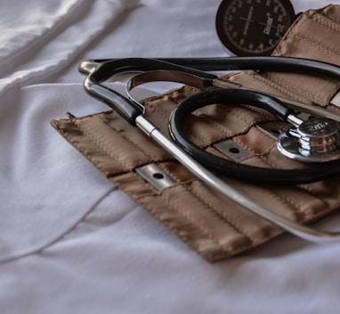 black stethoscope with brown leather case