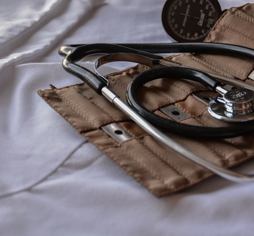 black stethoscope with brown leather case