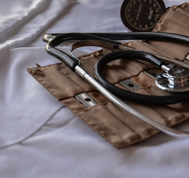 black stethoscope with brown leather case