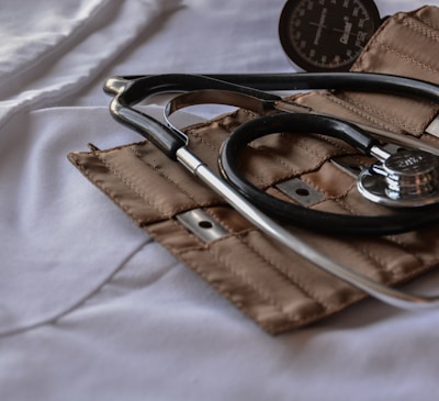 black stethoscope with brown leather case