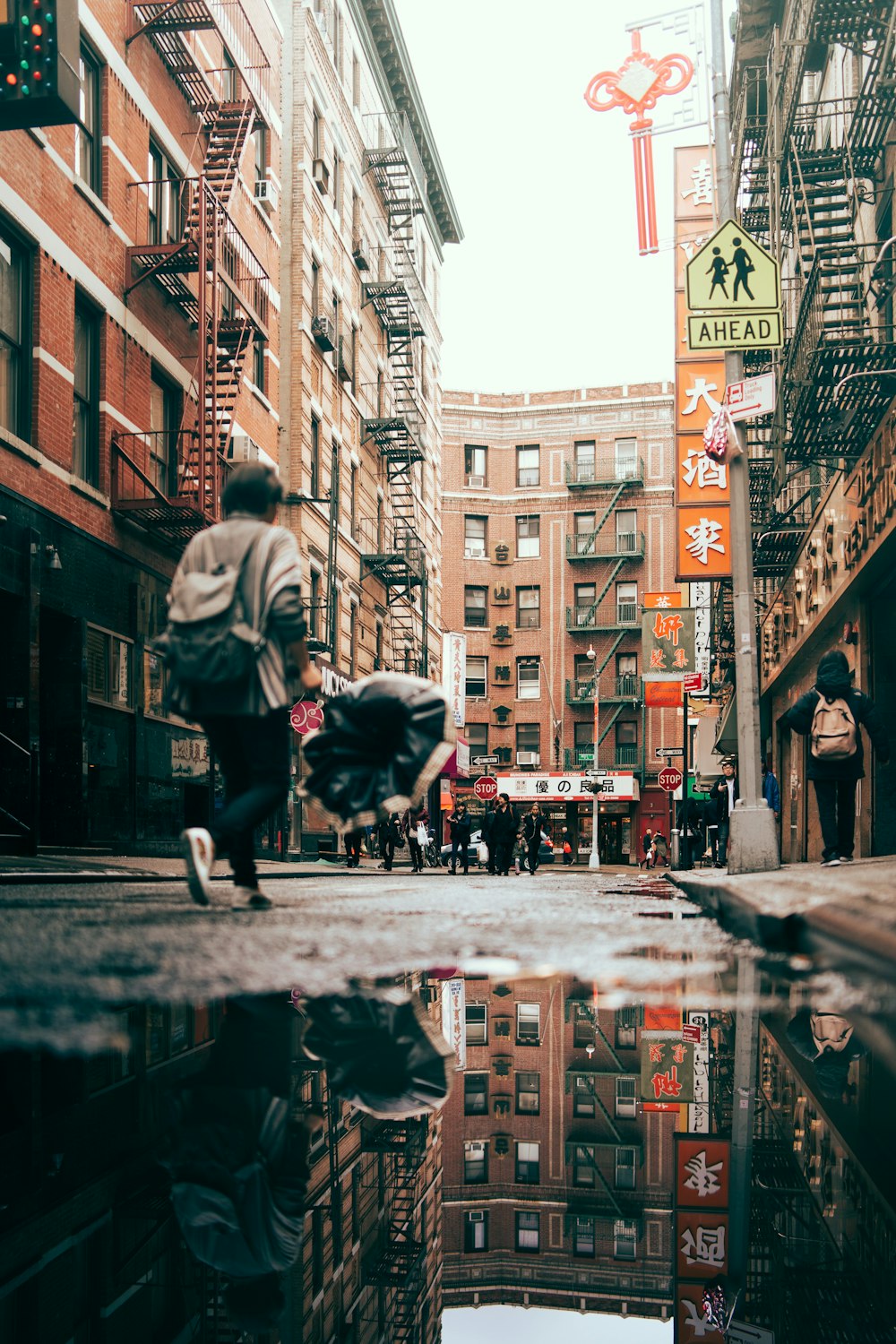 man walking near brown concrete buildings