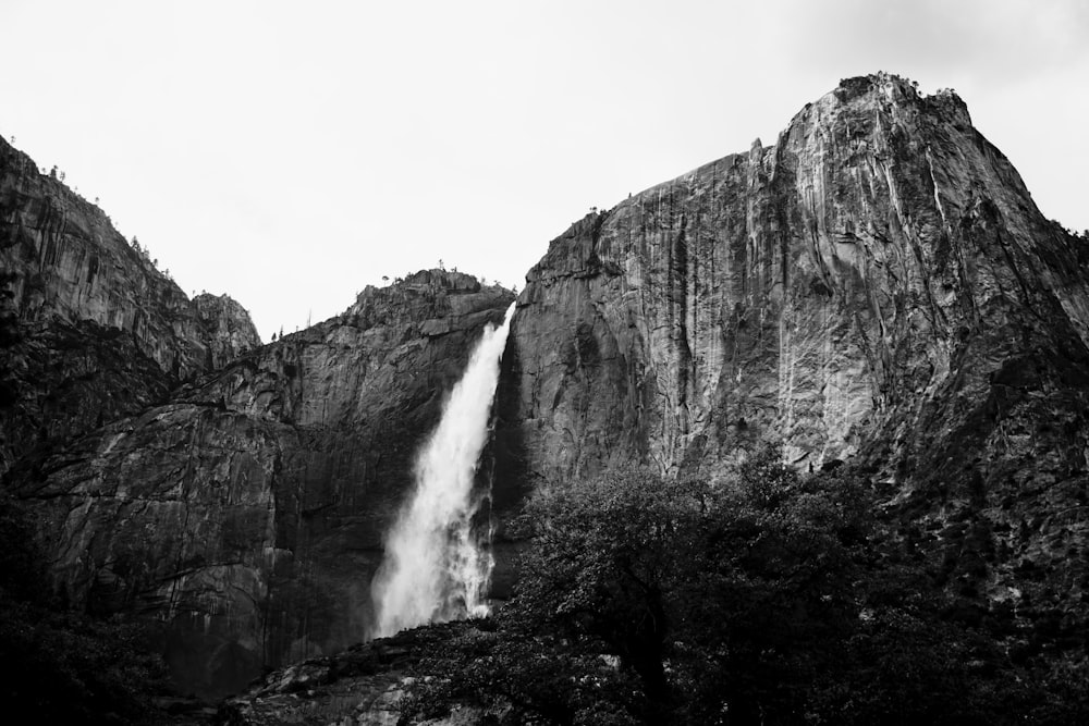 grayscale photography of plunge waterfall at daytime