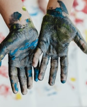 person hands with green paint