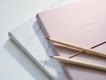 red and purple coloring pencils on pink journal