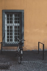 black bike parked near window