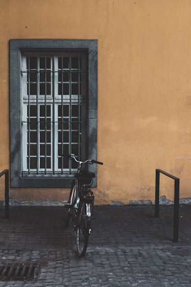 black bike parked near window