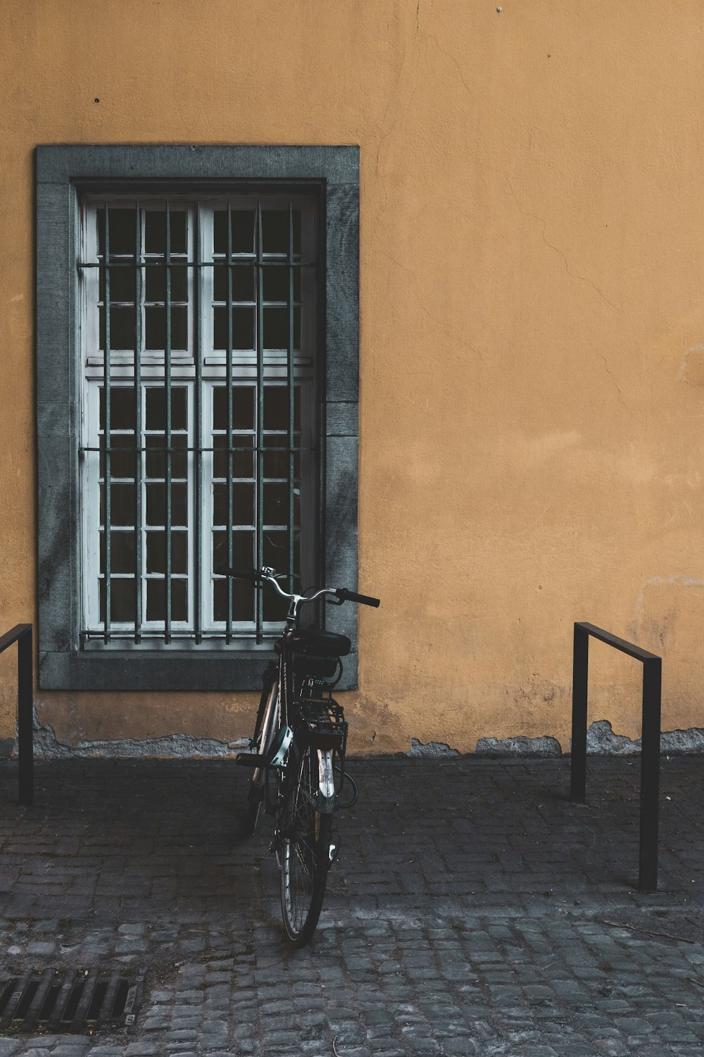 black bike parked near window