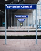 man in black pants under blue metal frame